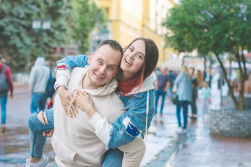 Happy loving young couple-girl and guy on a walk outside Sunny summer day.