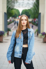 Beautiful model in fashionable clothes in the city park.