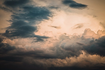 Stunning sky and sun behind dark grey clouds background.