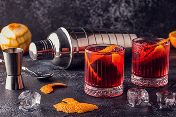 Negroni cocktail with orange peel and ice.