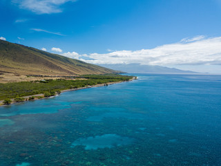 Fototapeta na wymiar Drone side view of the dry mountains and crystal clear waters of the Lahaina Coast on the island of Maui, Hawaii