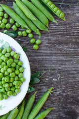 fresh pea on dark wooden surface