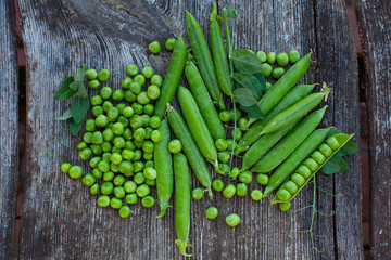 fresh pea on dark wooden surface