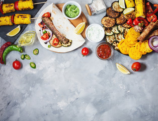Assorted delicious grilled vegetables and doner kebab on a concrete background. Summer food barbecue.