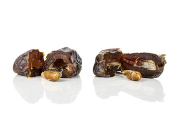 Group of four halves two pieces of dried brown date medjool isolated on white background