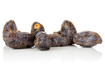 Lot of whole dried brown date medjool isolated on white background
