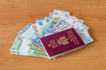 Fototapeta na wymiar Polish biometric passport and Belarusian and British Currency and EURO.