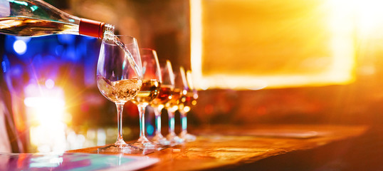 Wine serving in glasses in night club bar restaurant | Blurred background