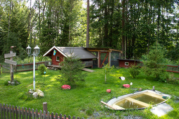 little red wooden cabin in the garden for animals