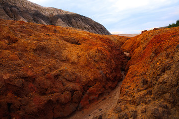 big hill of orange clay