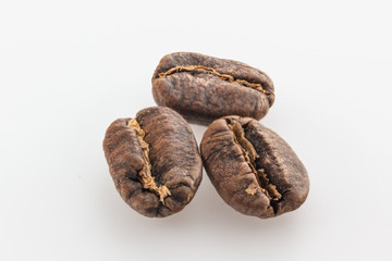 Coffee grains isolated on white background. Top view at an angle. For design.