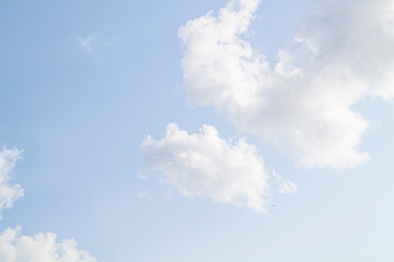 white clouds against the blue sky.