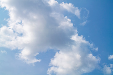 white clouds against the blue sky.