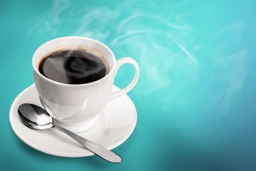 Coffee cup and spoon on wooden background
