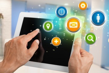 Male hands holding digital tablet with black screen, blurred floral background