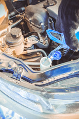 Pouring washer fluid into the car