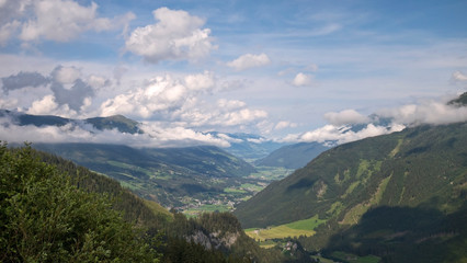 Beautiful view on Austrian valley with mountains and clouds 