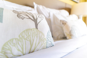 Fototapeta na wymiar Image of several pillows on bed with white blanket
