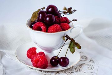 Cup with berries on white background