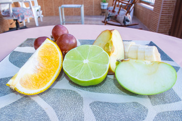 Sliced ​​fruits on a plate on the table