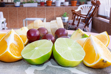 Several colorful fruits cut on a plate close up