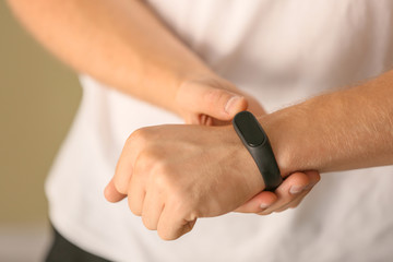Man with fitness tracker checking his pulse, closeup