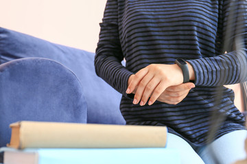 Woman checking her pulse at home