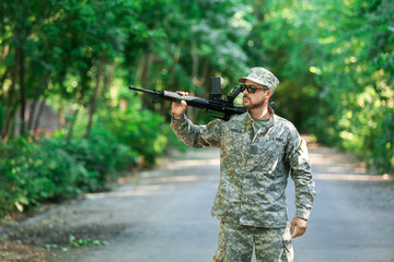 Soldier with assault rifle outdoors