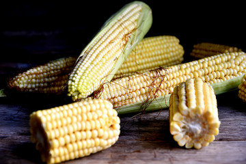 Young fruits of corn on an old rustic table.