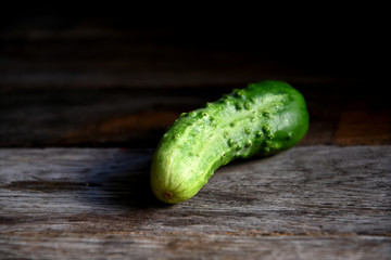 Cucumbers on an old wooden table.