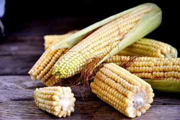 Young fruits of corn on an old rustic table.