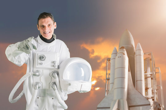 astronaut holding helmet space suit and smiling - Powered by Adobe
