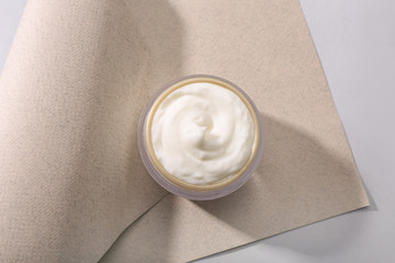 Jar of natural cream on light background