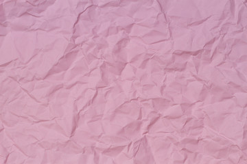 Pink crumpled wrinkled paper texture background