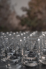 Vertical image of many glass glasses in a bar - Luxurious and shiny glasses