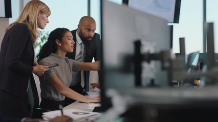 business woman team leader meeting with colleagues using computer pointing at screen office manager sharing ideas helping coworkers discussing strategy in corporate workplace - Powered by Adobe