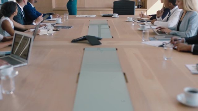business woman presenting financial data on tv screen sharing project with shareholders team leader briefing colleagues discussing company growth ideas in office boardroom presentation