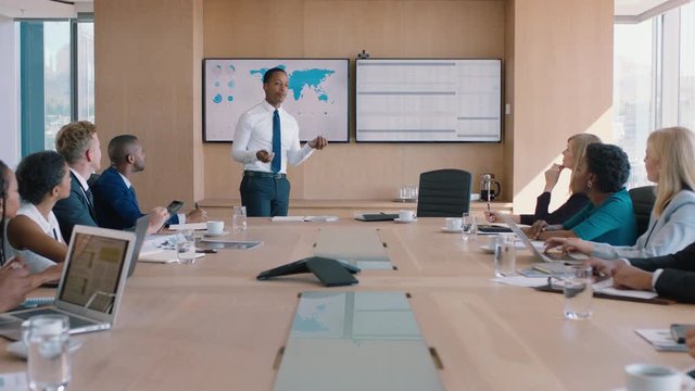 businessman presenting financial data on tv screen sharing project with shareholders team leader briefing colleagues discussing company growth ideas in office boardroom presentation