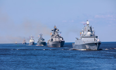 Fototapeta na wymiar A line ahead of modern russian military naval battleships warships in the row, northern fleet and baltic sea fleet, summer sunny day