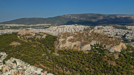 Fototapeta na wymiar Aerial drone photo of iconic Lycabettus hill and iconic chapel of Saint George on top in cityscape of Athens, Attica, Greece