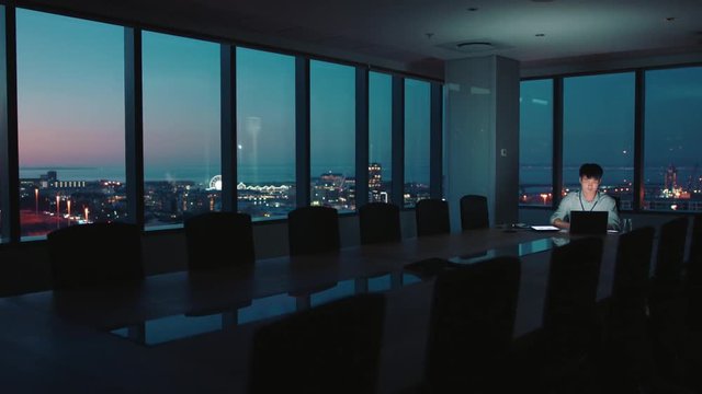 asian businessman working late using laptop computer in office project manager brainstorming ideas for company focused on deadline