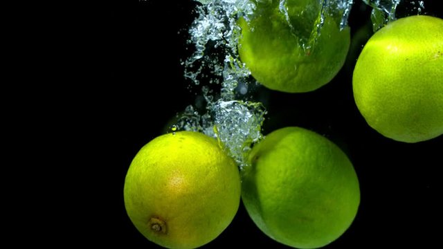 Super slow motion of falling lime pieces into splashing water. Filmed on high speed cinema camera, 1000 fps.