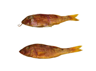 Dried two Mullus fishes on the table. Salty dry  fish on a white background. Dead dry salty fish - snack to beer. Isolated on white. Soft focus