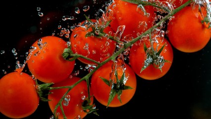 Super slow motion of falling tomatoes into water. Filmed on high speed cinema camera, 1000fps - Powered by Adobe