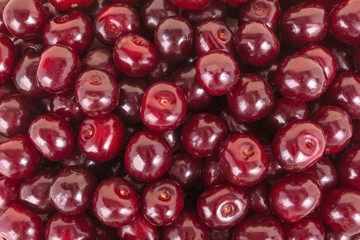 Background from cherry berries.Close up.Fresh red ripe juicy berries.Сoncept of textural surface, decoration, design for wallpapers, patterns, calendars.