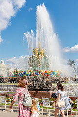 Stone Flower Fountain in VDNH park in Moscow against blue sky at sunny summer day. Exhibition of Achievements of National Economy is russian popular touristic landmark