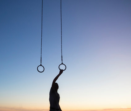 Man exercising on gymnastic rings