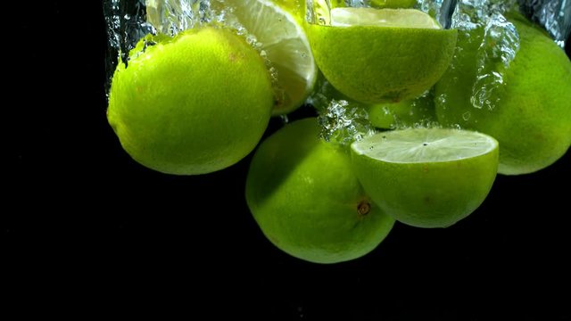 Super slow motion of falling lime pieces into splashing water. Filmed on high speed cinema camera, 1000 fps.