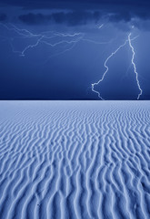 Thunderbolts of lightning over desert at night