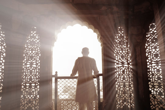 Rear view of man standing on balcony